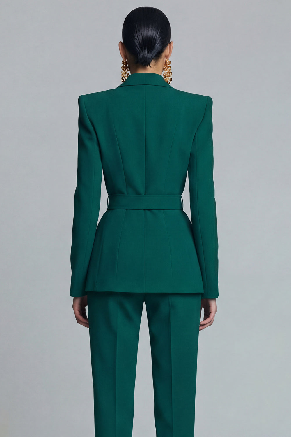 Close-up back view of emerald green fitted blazer with back belt strap structured seams and tailored waist – Una Una