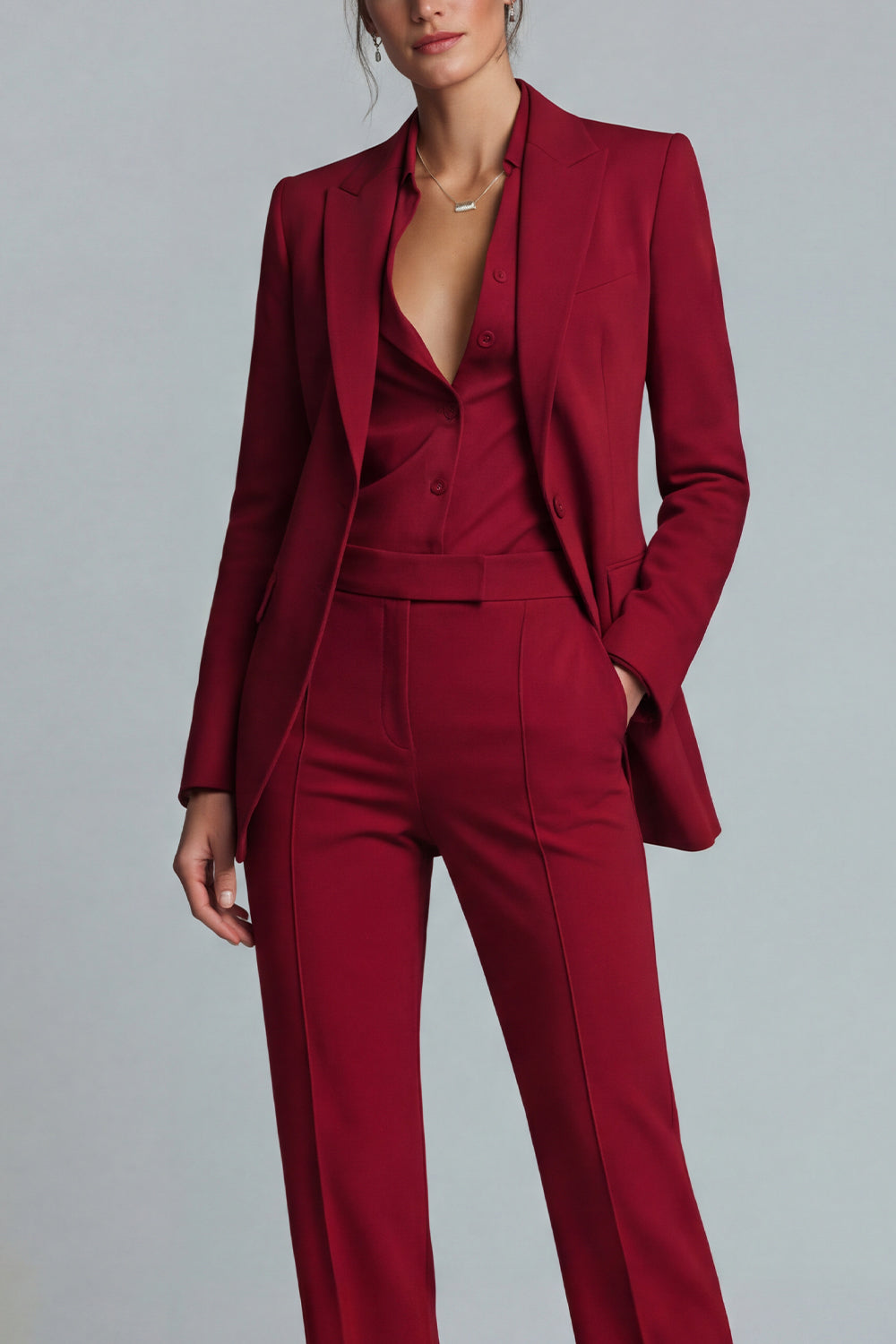 Close-up of burgundy notch lapel open-front blazer layered over matching button-front vest with front seam trouser detail – Una Una

