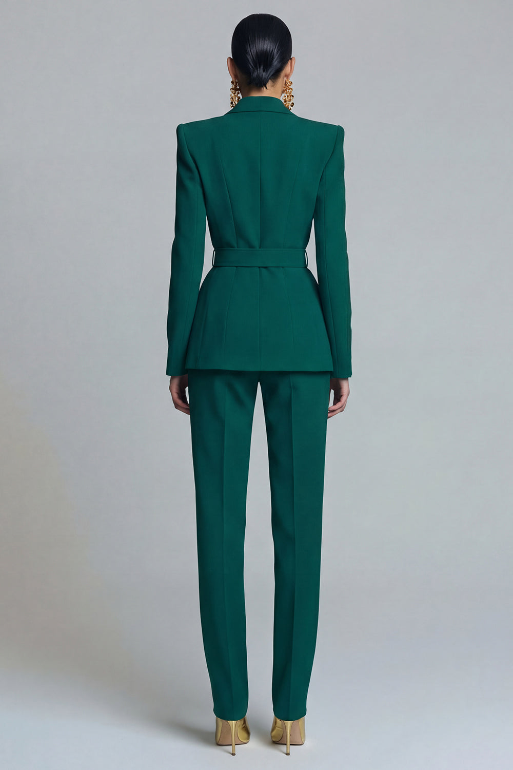 Women's emerald green belted blazer and slim tapered trouser suit set back view with structured seam and belt detail – Una Una

